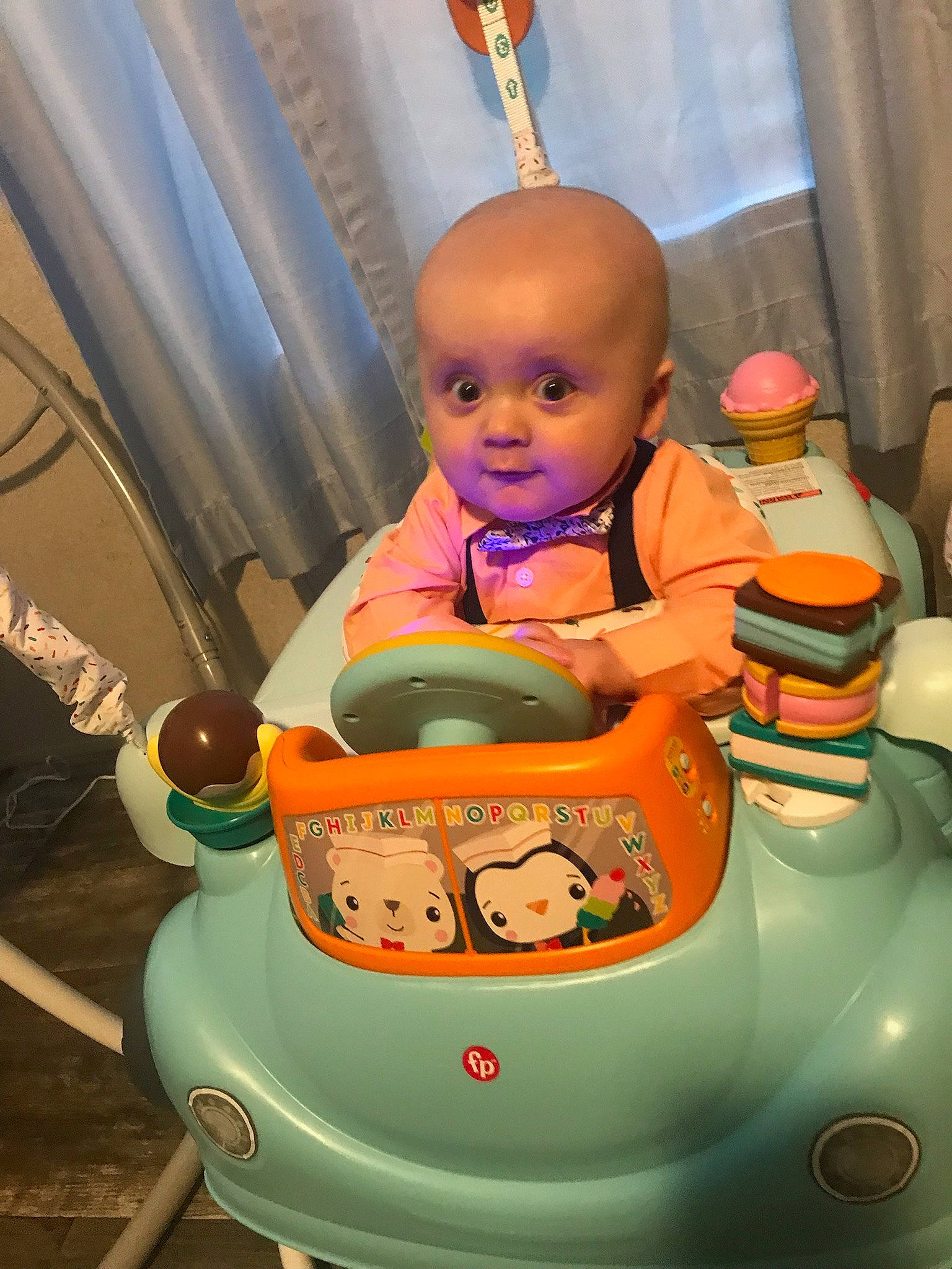 Liam joined the competition — help win amazing prizes! automotive_design, baby, baby_products, baby_toys, child, curtain, fictional_character, fun, leisure, motor_vehicle, orange, person, product, recreation, riding_toy, room, sitting, toddler, toy_vehicle, wheel
