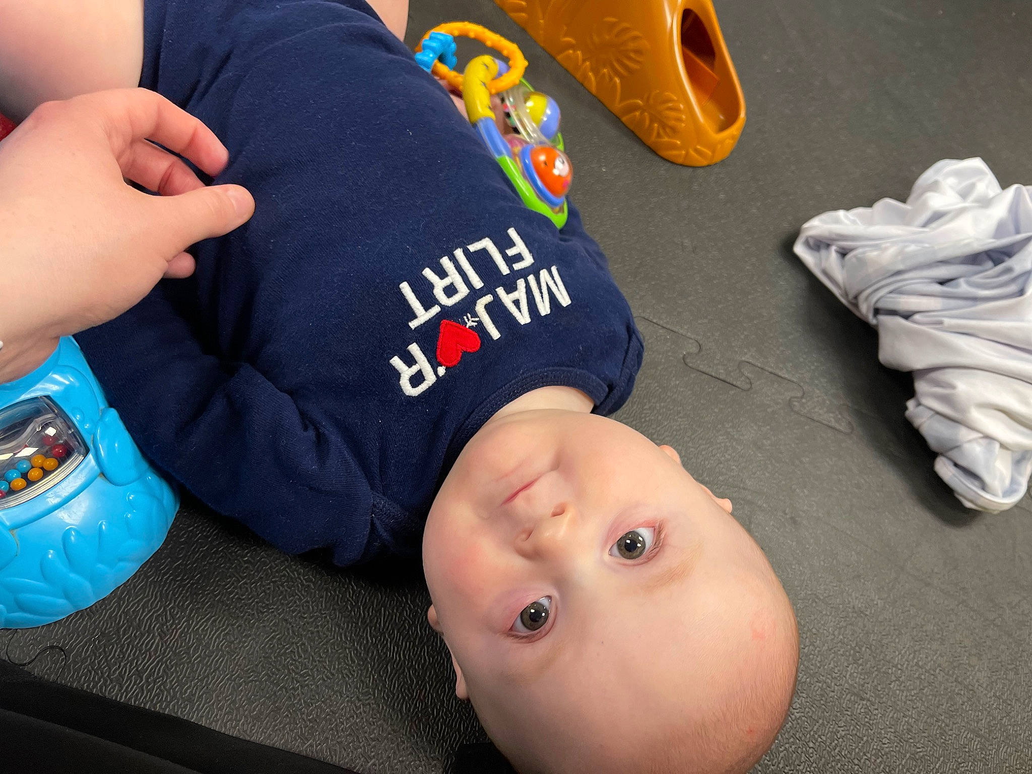 Liam is registered to the contest to win money with this photo: baby, baby_toddler_clothing, carmine, cheek, child, comfort, elbow, finger, flooring, fun, gesture, happy, joint, mammal, person, room, sitting, sleeve, thumb, toddler