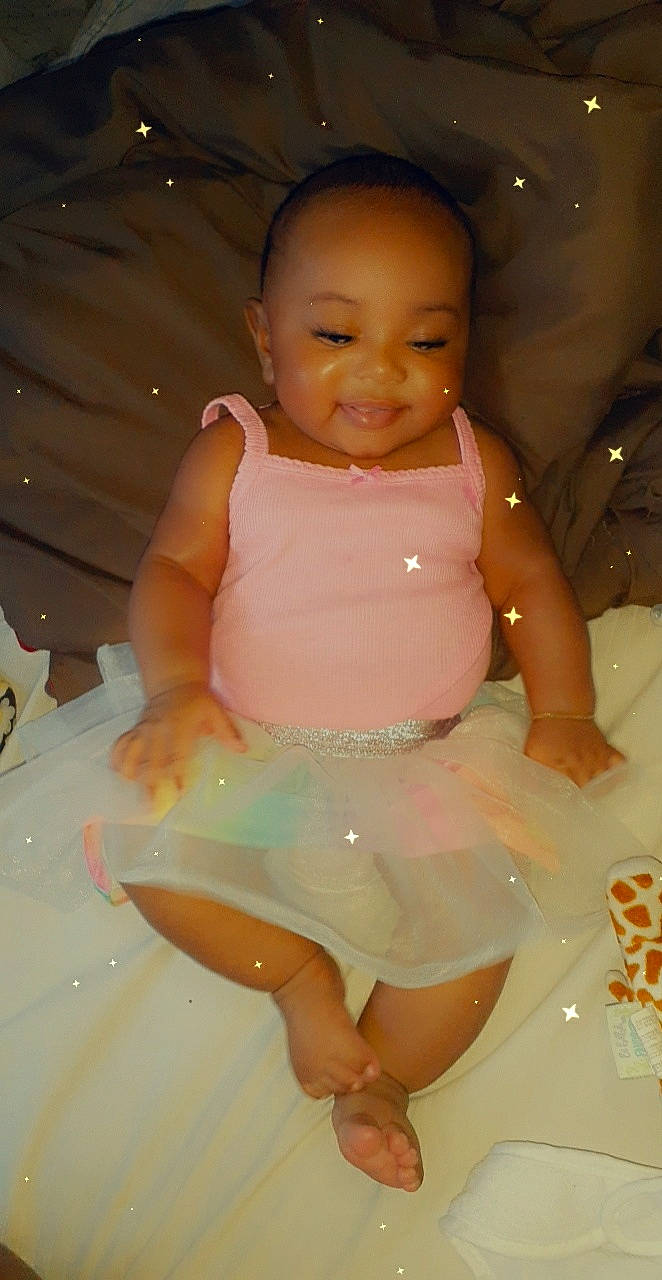 Karma is registered to the contest to win money with this photo: baby, baby_toddler_clothing, bathing, cheek, child, fun, joy, person, pink, skin, smile, toddler