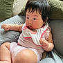 Isla joined the competition — help win amazing prizes! baby, infant, child, cushion, pillow, green_pillow, gray_cushion, striped_clothing, bib, watermelon_design, curious_gaze, chubby_arms, indoors, soft_texture, relaxed, seated, cute, portrait, comfortable, hair
