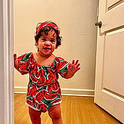 Cattleya joined the competition — help win amazing prizes! toddler, child, standing, watermelon_print, headband, red_shoes, doorway, wooden_floor, smiling, curly_hair, indoor, cute, fashion, happy, person, clothing, footwear, playful, young_child, portrait