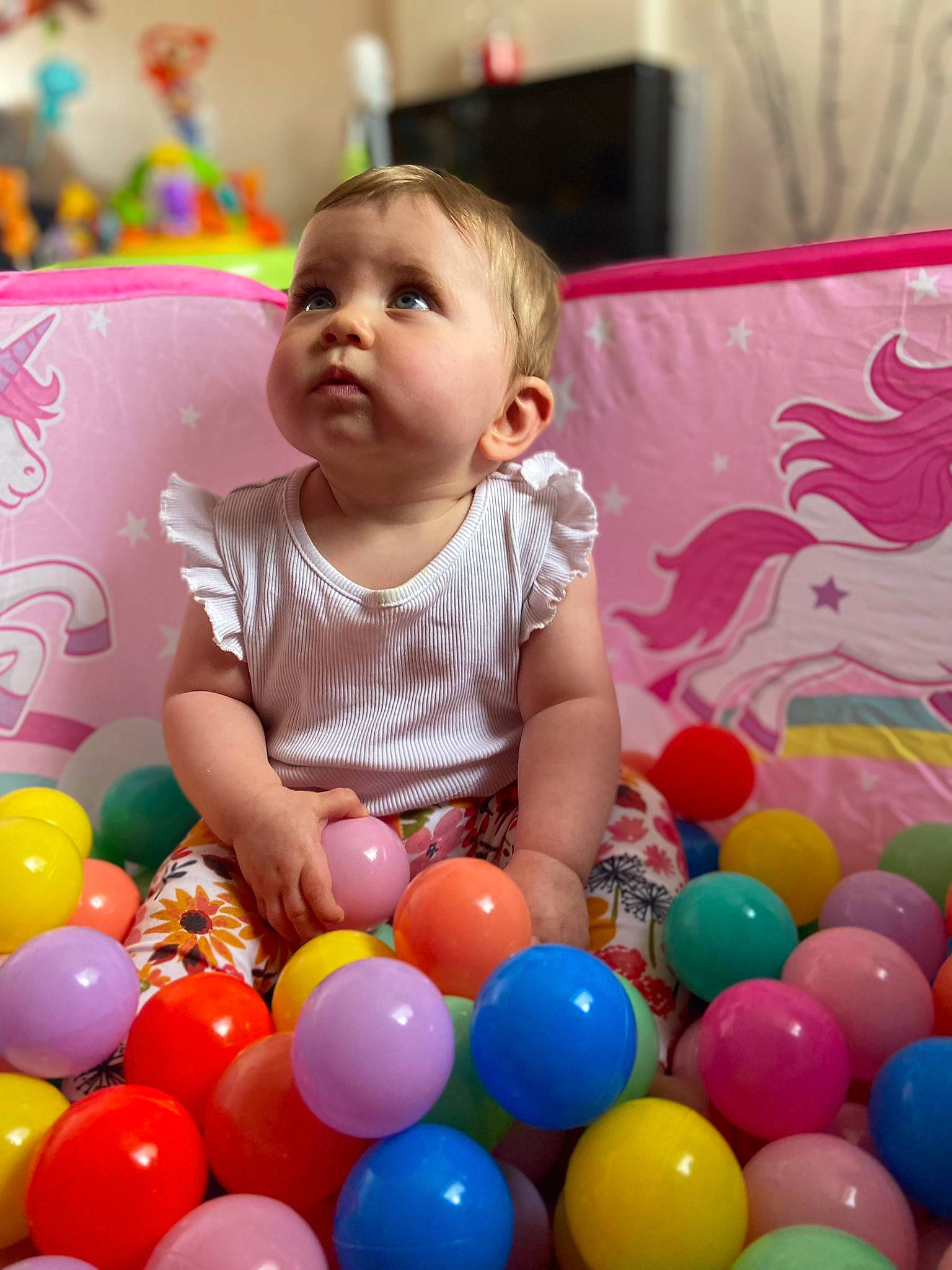Isla is registered to the contest to win money with this photo: baby, baby_playing_with_toys, ball, ball_pit, balloon, child, event, facial_expression, fun, happy, leisure, party_supply, people, person, photograph, play, product, snapshot, toddler, toy