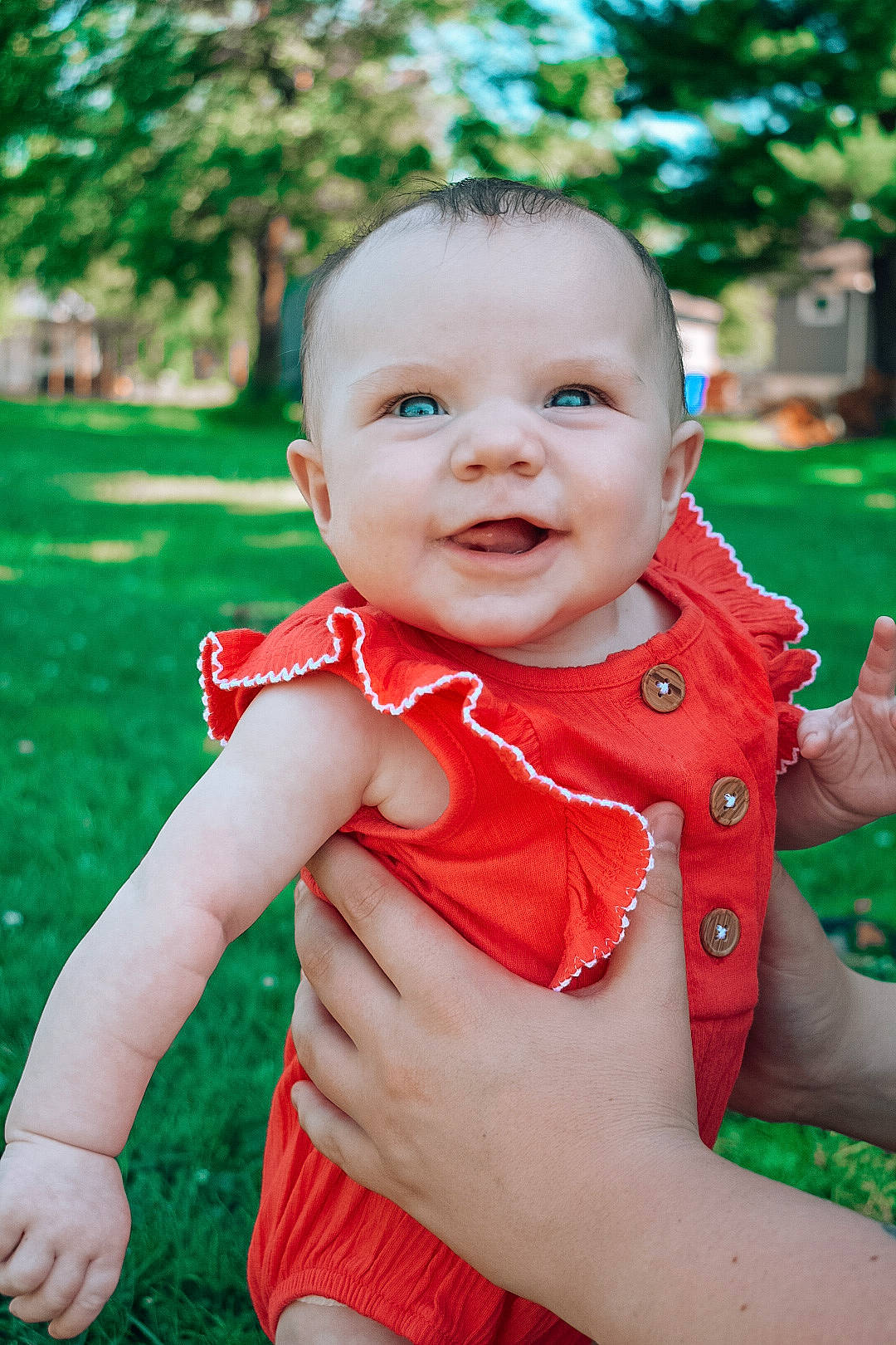 Braelynn is registered to the contest to win money with this photo: arm, baby, baby_toddler_clothing, cheek, chin, dress, finger, gesture, green, hairstyle, hand, happy, iris, lip, nose, people_in_nature, person, plant, skin, smile