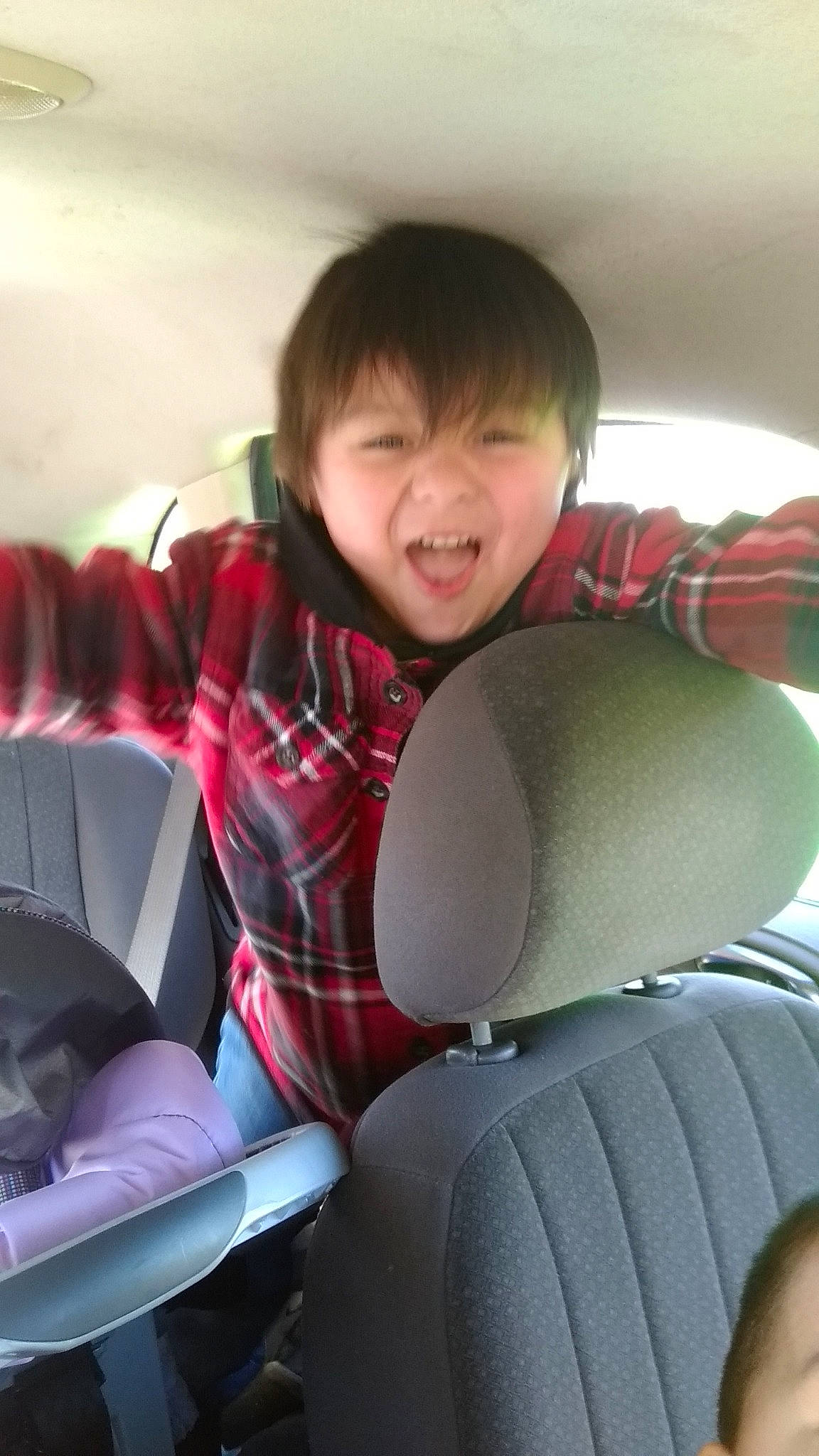 Alejandro joined the competition — help win amazing prizes! car_seat, child, cool, day, fun, girl, lap, leg, mouth, person, product, red, sitting, smile, textile, toddler