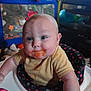 baby, baby_food, black, blue_eyes, child, curious_expression, cute, face, feeding_time, high_chair, home, indoor, infant, messy_face, person, pink, playpen, sitting, toys, yellow_shirt
