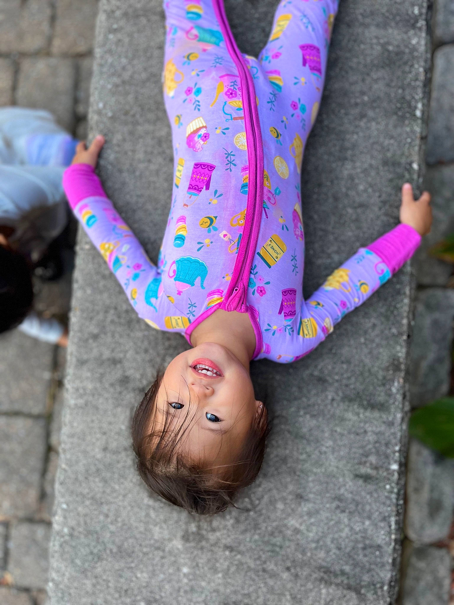 Peyton is registered to the contest to win money with this photo: carmine, child, dress, fashion_accessory, foot, glove, grass, human_body, human_leg, magenta, nail, pattern, person, pink, plant, red, sitting, sleeve, textile, tree