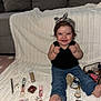 Aylani is registered to the contest to win money with this photo: toddler, child, smiling, headband, jeans, barefoot, makeup, cosmetics, lipstick, perfume, nail_polish, foundation, blush, eyeliner, cosmetic_bag, blanket, sofa, indoor, happy, cute