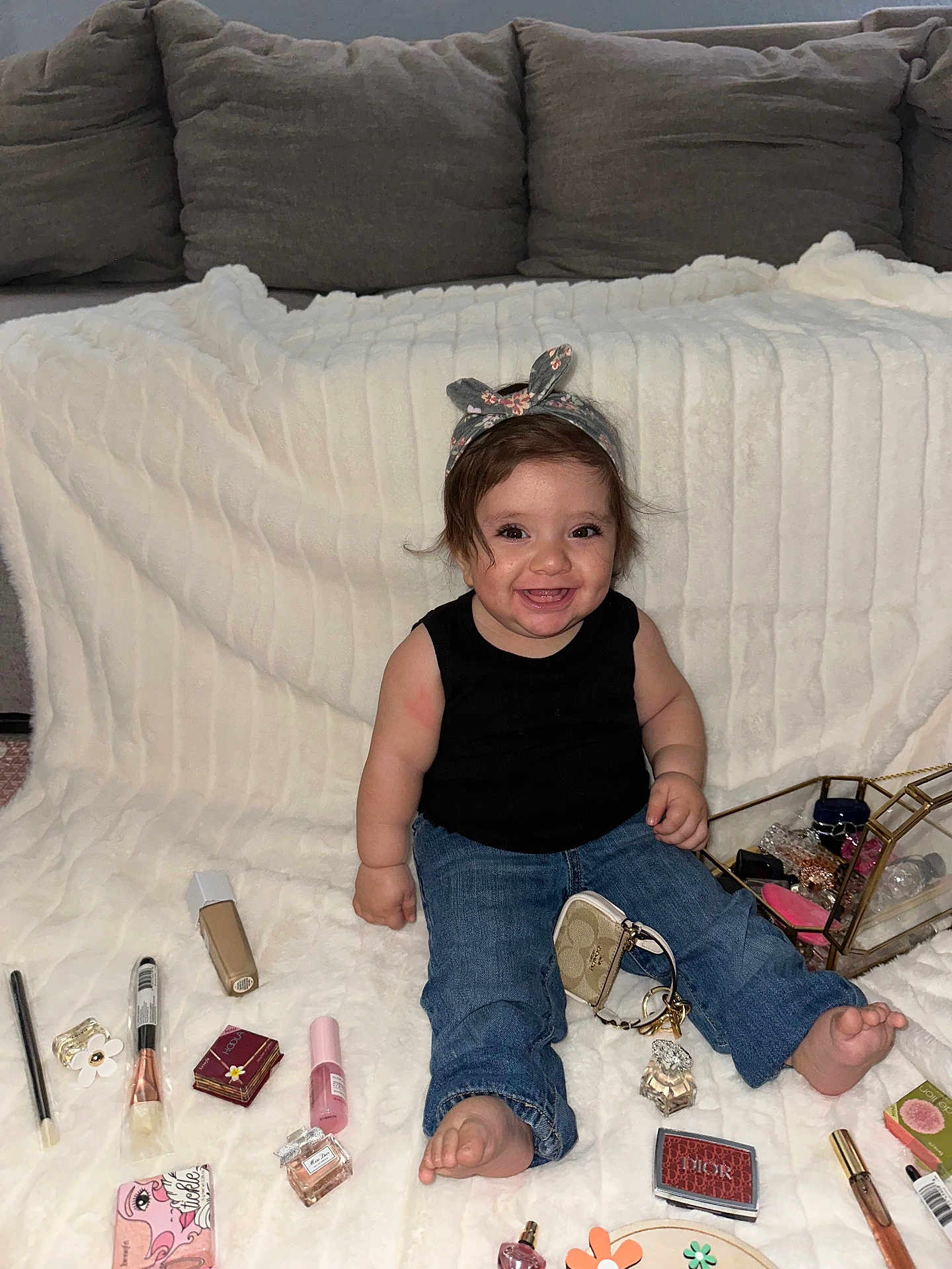 Aylani joined the competition — help win amazing prizes! baby, child, smiling, headband, jeans, black_shirt, makeup, cosmetics, perfume, blanket, sitting, barefoot, accessories, purse, cute, indoors, happy, face, person, portrait