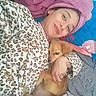 Layla Lozano is registered to the contest to win money with this photo: woman, dog, pet, cuddling, leopard_print, pajamas, towel, turban, bed, blanket, indoor, smile, cozy, cute, relaxation, comfort, golden_dog, face, portrait, resting