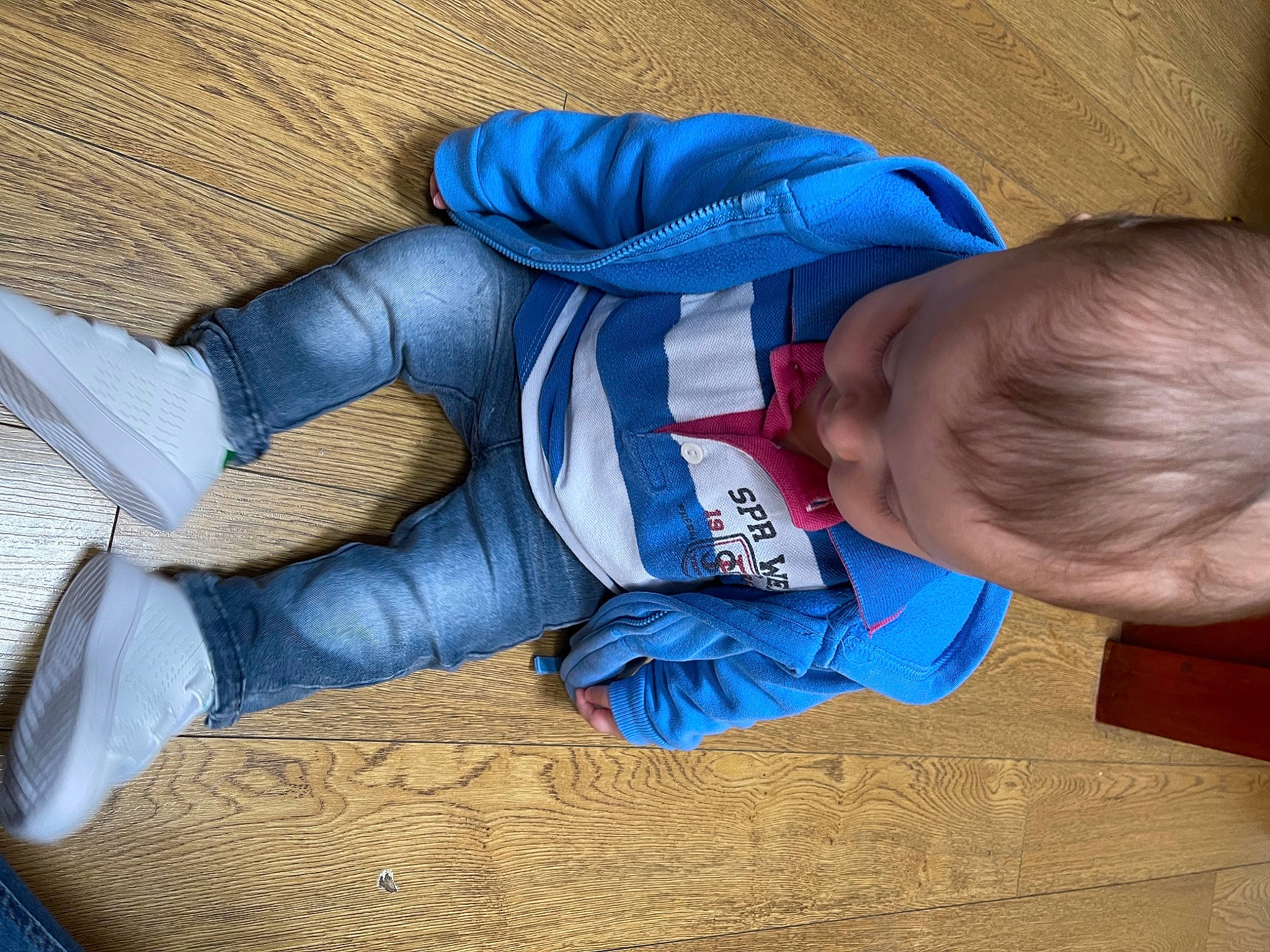 Konstantinos is registered to the contest to win money with this photo: arm, baby, baby_sleeping, baby_toddler_clothing, blue, carmine, child, comfort, elbow, electric_blue, flooring, human_body, linens, mammal, person, sitting, sleeve, textile, toddler, wood