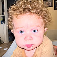 Greyson is registered to the contest to win money with this photo: baby, background, blue_eyes, child, clothing, curly_hair, cute, expression, face, framed_pictures, head, home, indoor, looking, person, photography, portrait, pout, skin, young_child