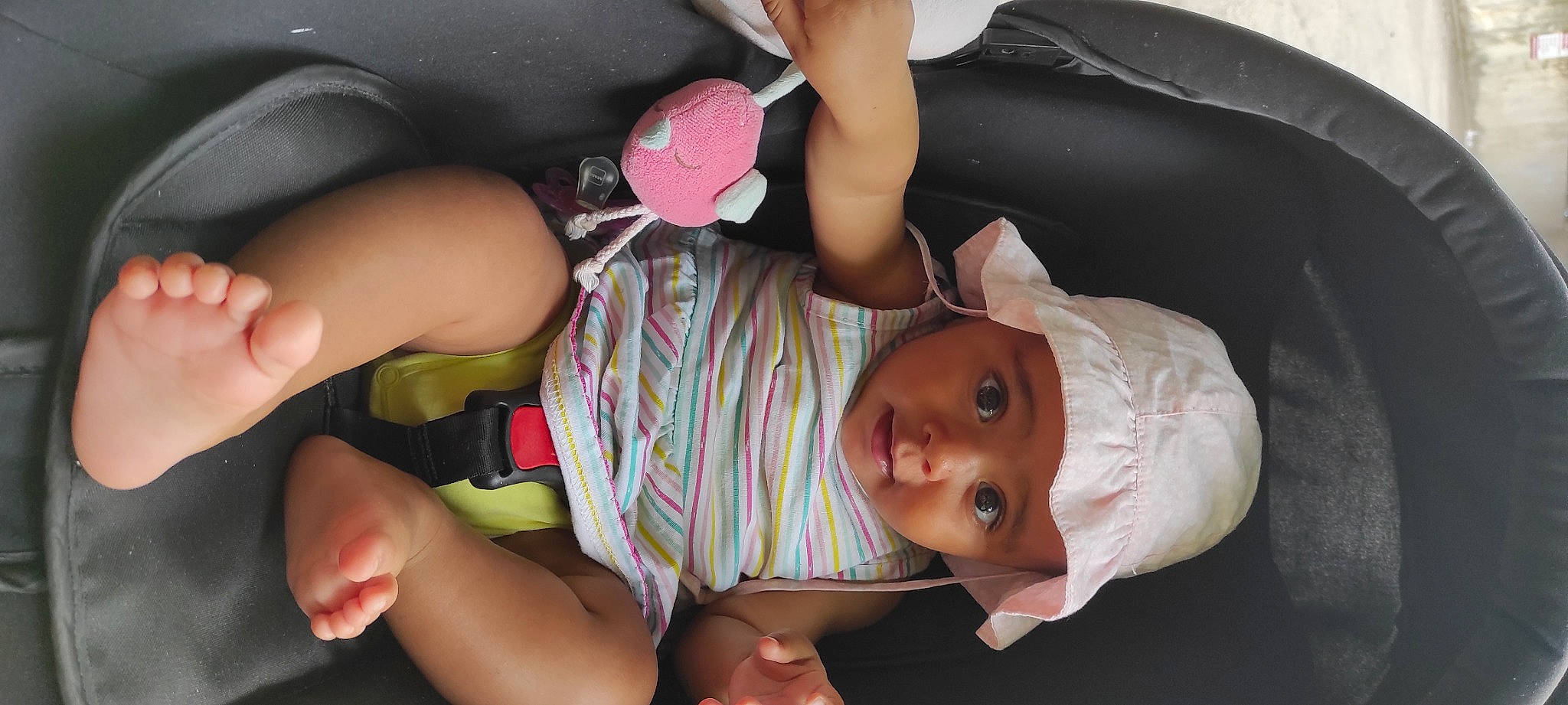 Emily participe au concours pour gagner de l'argent avec cette photo : baby, baby_carriage, baby_in_car_seat, baby_products, baby_toddler_clothing, car_seat, cheek, child, comfort, fun, headwear, human_leg, leg, mouth, nail, person, pink, skin, sock, thigh