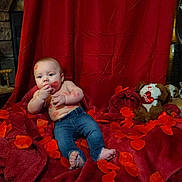 Sawyer joined the competition — help win amazing prizes! baby, infant, child, jeans, bare_torso, lipstick_kisses, red_petals, red_blanket, red_backdrop, teddy_bear, plush_toy, heart, valentine_theme, dog_face, indoor, portrait, stone_wall, wooden_chair, blanket, cute