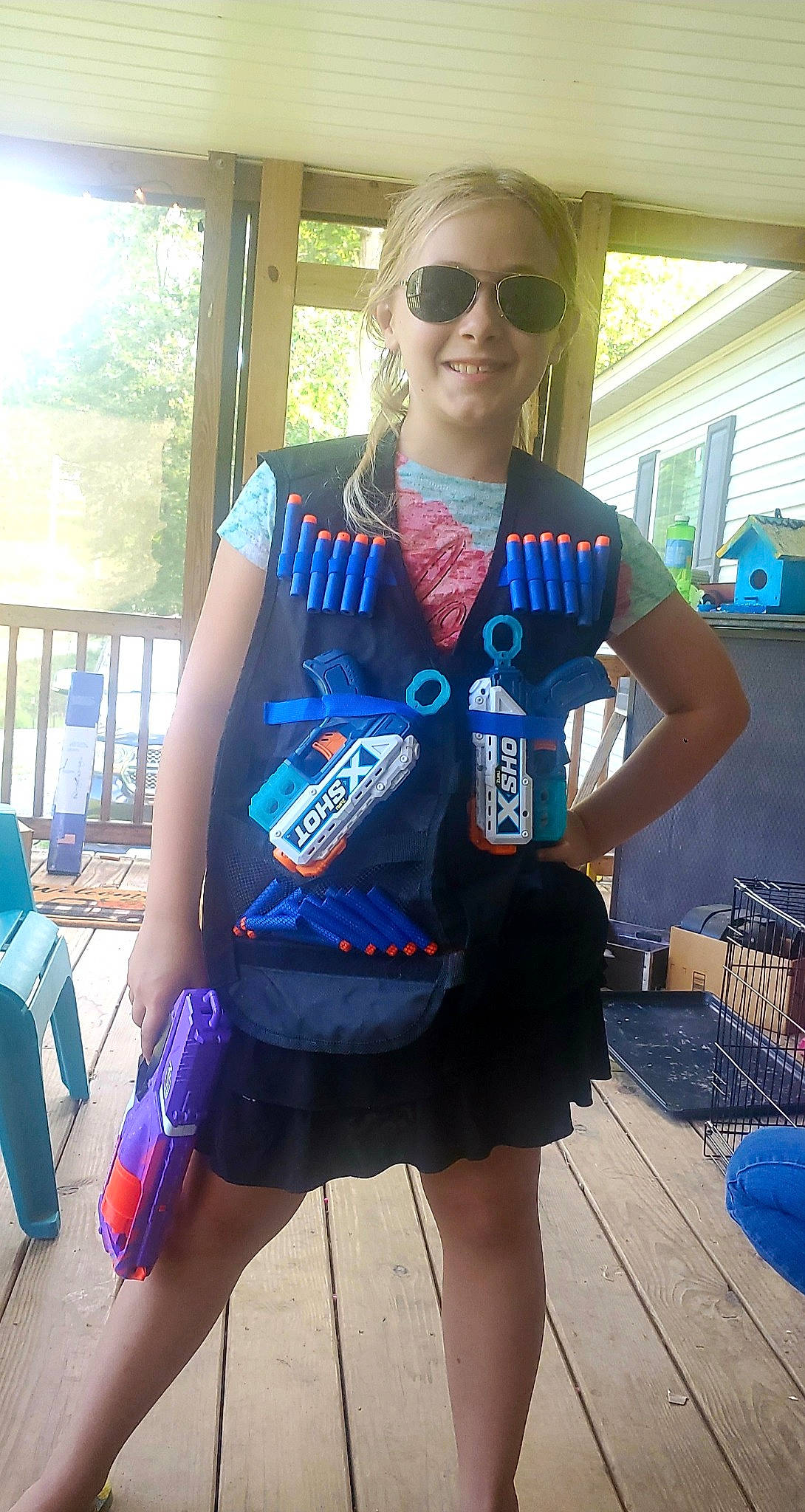 Megan is registered to the contest to win money with this photo: blue, electric_blue, eyewear, fashion_design, glasses, goggles, human_leg, joy, leisure, person, personal_protective_equipment, recreation, sleeve, smile, sportswear, street_fashion, sunglasses, t_shirt, textile, thigh