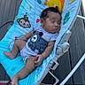Taaytum is registered to the contest to win money with this photo: baby, sleeping, baby_rocker, outdoor, deck, infant, clothing, cute, animal_print, colorful, peaceful, child, furniture, footwear, person, portrait, relaxing, seat, toy, home