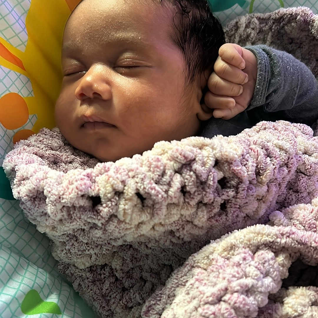 Taaytum is registered to the contest to win money with this photo: baby, sleeping, blanket, infant, child, face, hand, soft_texture, cozy, patterned, colorful, baby_seat, animal_design, peaceful, resting, portrait, indoors, cute, newborn, warm