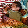 Taaytum is registered to the contest to win money with this photo: baby, sleeping, blanket, crochet, colorful, pattern, texture, infant, peaceful, cozy, child, portrait, resting, soft, cute, clothing, hand, face, indoors, comfort