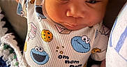 Taaytum is registered to the contest to win money with this photo: baby, infant, onesie, cookie_monster, blanket, crochet, milk_carton, clothing, child, cute, face, hand, lying_down, indoors, portrait, young_child, sleepwear, patterned_clothing, soft_toys, resting