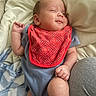 Ronan is registered to the contest to win money with this photo: baby, infant, smile, red_bib, blue_onesie, blanket, bed, soft_fabric, comfort, resting, cute, skin, face, hand, leg, indoors, cozy, child, newborn, portrait