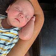 Ronan is registered to the contest to win money with this photo: baby, sleeping, arm, onesie, striped_clothing, boat_pattern, bottle, infant, closeup, resting, peaceful, skin, person, furniture, couch, relaxation, newborn, cute, hand, nap