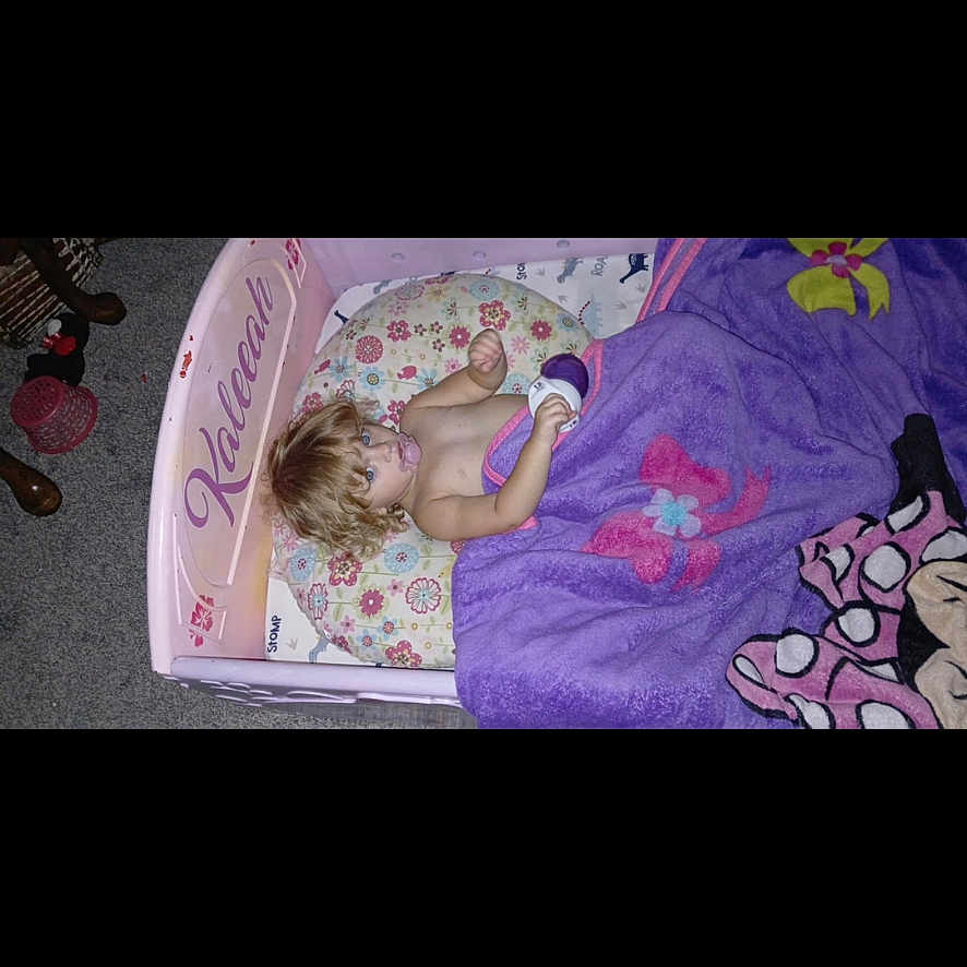 Kaleeah joined the competition — help win amazing prizes! baby, bed, clothing, crib, cushion, face, footwear, furniture, head, homedecor, indoors, infantbed, interiordesign, person, photography, portrait, purple, quilt, shoe, sleeping