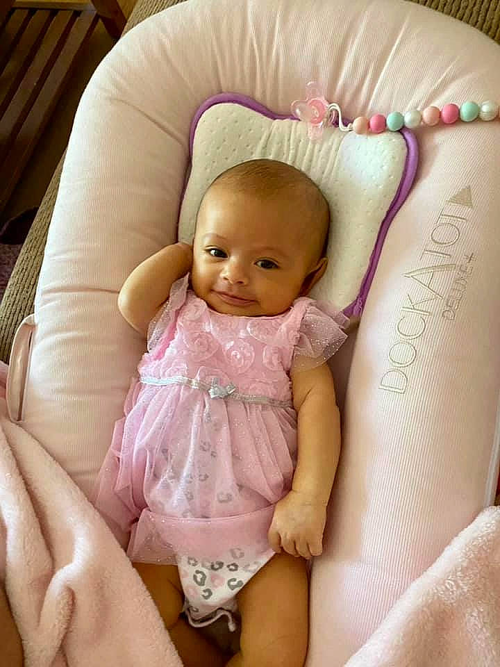 Miya is registered to the contest to win money with this photo: baby, baby_toddler_clothing, cheek, chest, comfort, eye, face, finger, hairstyle, head, nail, organ, person, pink, product, skin, smile, textile, thigh, thumb