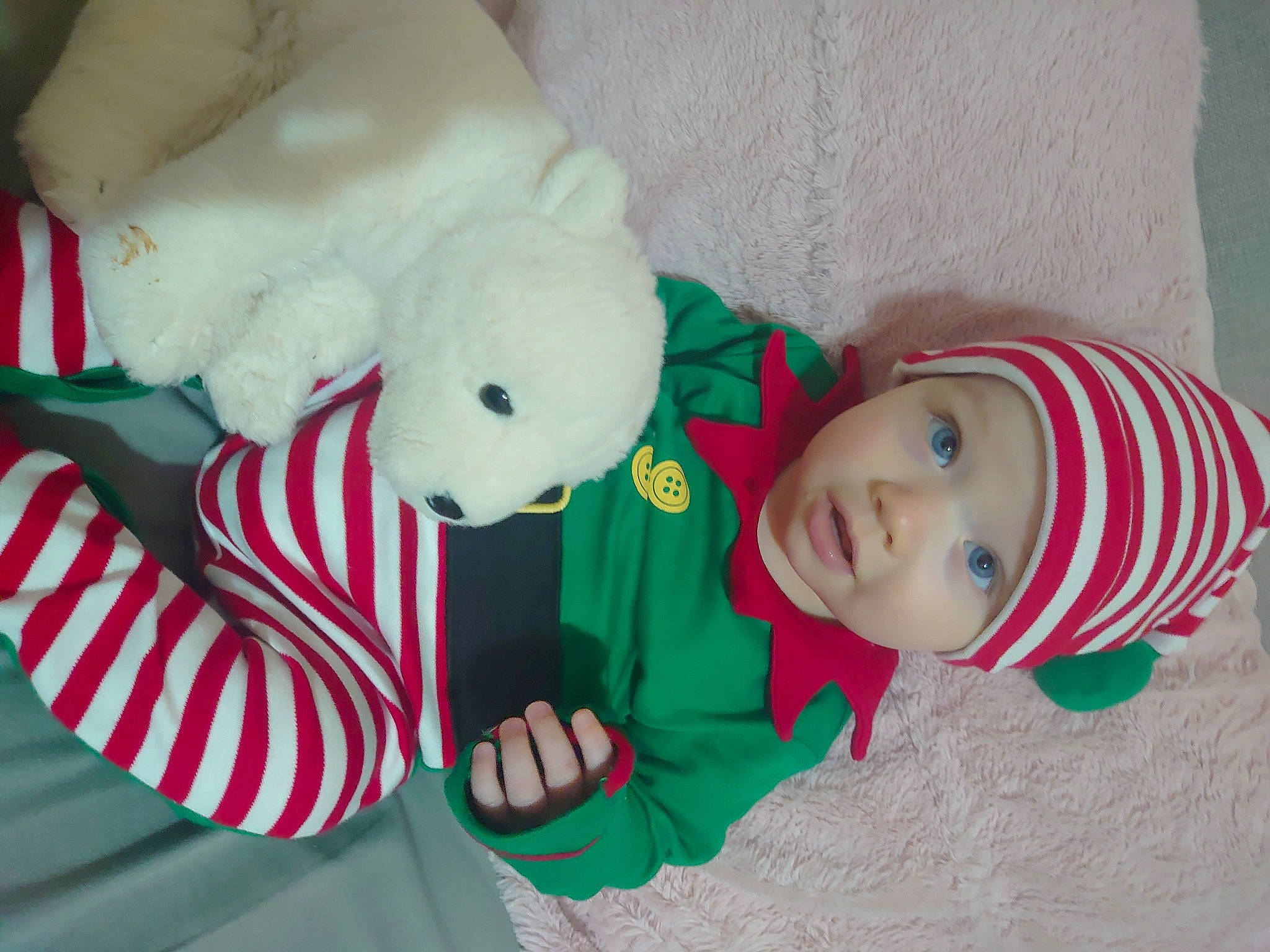 Mckenzie is registered to the contest to win money with this photo: baby, baby_toddler_clothing, carmine, child, christmas, christmas_eve, event, fictional_character, hat, headwear, holiday, lap, linens, person, plush, room, sleeve, stuffed_toy, textile, toddler