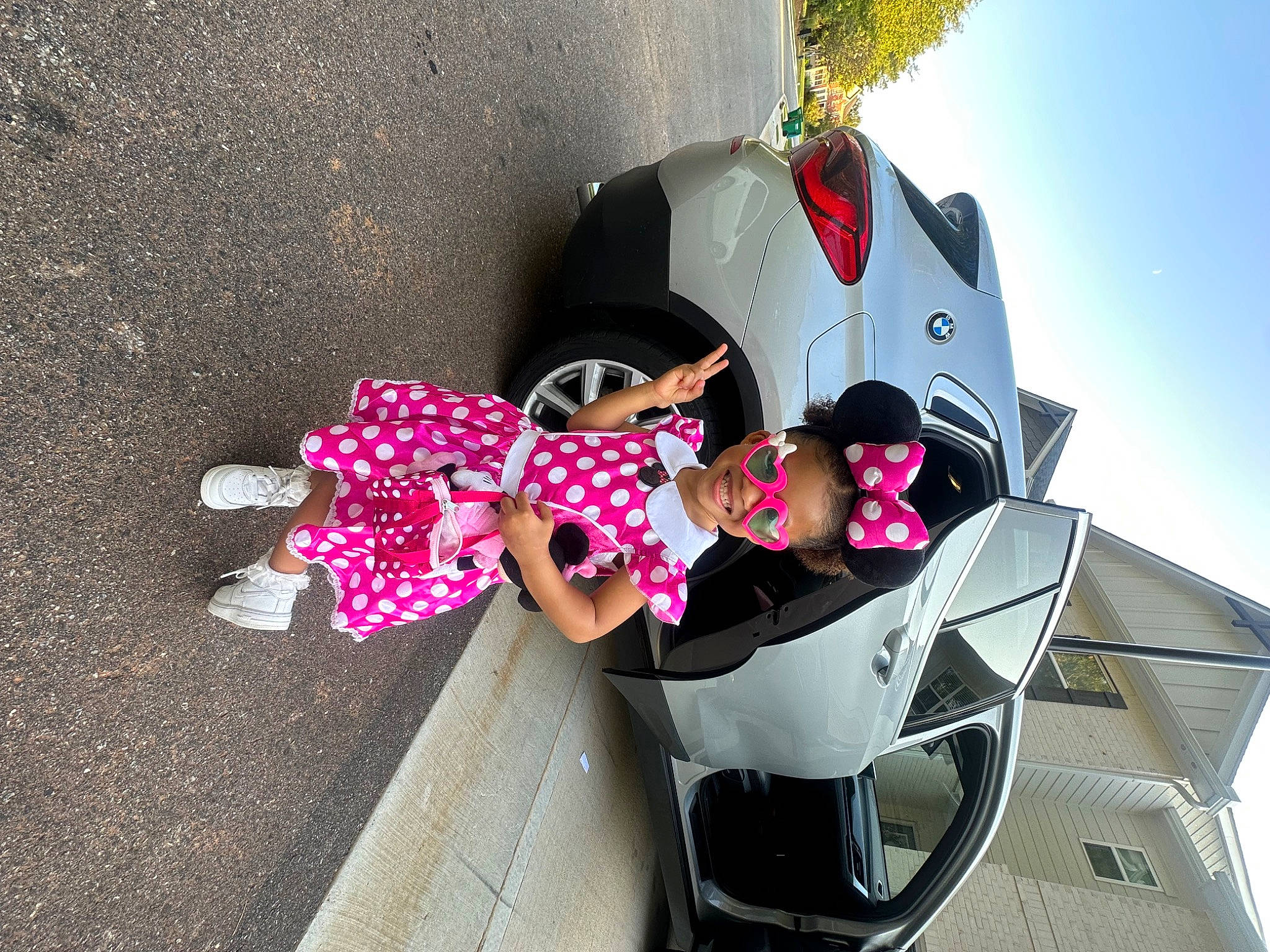 Milan is registered to the contest to win money with this photo: asphalt, auto_part, automotive_design, automotive_exterior, automotive_lighting, automotive_wheel_system, bumper, carmine, child, fun, joy, leisure, motor_vehicle, person, pink, recreation, tire, toddler, toy, tree