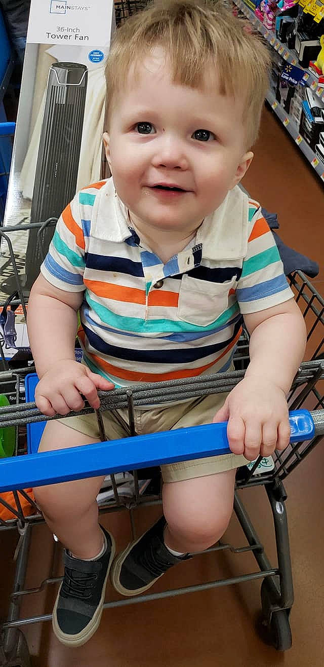 Logan is registered to the contest to win money with this photo: bicycle, bicycle_wheel, child, leg, person, play, smile, thigh, toddler, vehicle