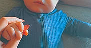 Kane joined the competition — help win amazing prizes! baby, blanket, blue_onesie, child, comfort, curious, face, gentle, hand, holding_hand, indoor, infant, lying_down, newborn, peaceful, person, portrait, skin, soft_texture, young_child
