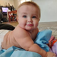 Dean is registered to the contest to win money with this photo: baby, diaper, blue_eyes, drool, blanket, living_room, floor, furniture, television, chair, curious, child, infant, crawling, cute, soft_toys, home, indoor, person, smiling