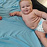 Dean is registered to the contest to win money with this photo: baby, infant, diaper, smile, drool, chubby, skin, blanket, blue, cute, happy, lying_down, indoor, person, child, plump, face, arm, floor, relaxed