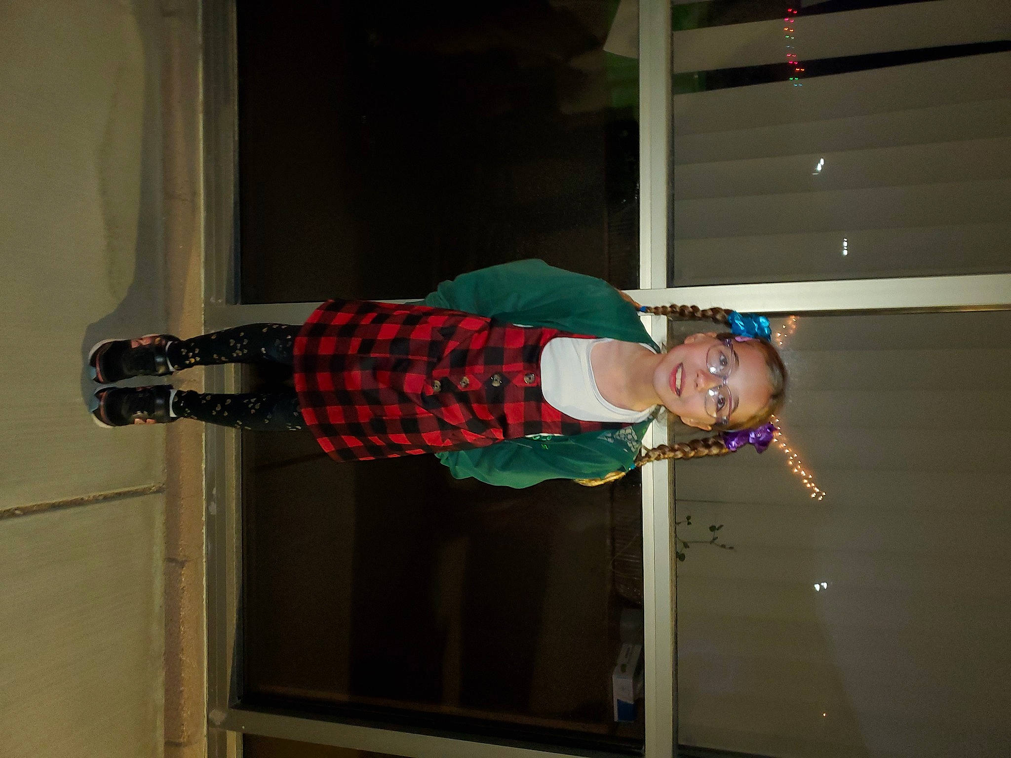 Gwendolyn is registered to the contest to win money with this photo: door, elbow, hat, human_leg, joy, knee, pattern, person, plaid, room, sleeve, smile, tartan, walking_shoe, wood
