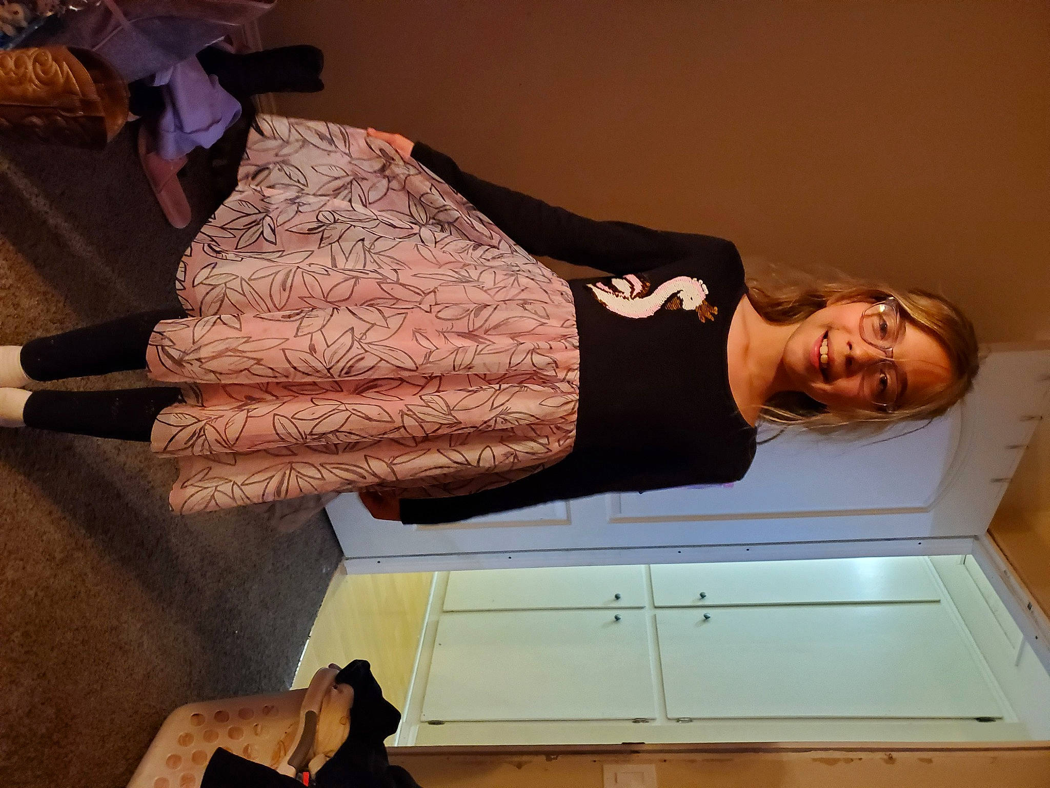 Gwendolyn is registered to the contest to win money with this photo: black, brown, comfort, dress, elbow, fashion_design, fun, gesture, hardwood, human_leg, joy, peach, person, room, shoulder, sleeve, smile, thigh, tints_and_shades, waist