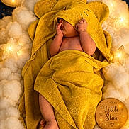 Ahmed is registered to the contest to win money with this photo: baby, towel, yellow, clouds, lights, moon, stars, wooden_plaque, sleeping, cute, newborn, soft, cozy, nursery, child, wrapped, adorable, warm_lighting, decor, face_hidden