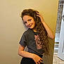 Diana is registered to the contest to win money with this photo: child, girl, long_hair, curly_hair, tshirt, leggings, posing, indoor, wall, smiling, hand_on_hip, casual, young, person, floor, door, bathroom, tile_floor, hair, portrait