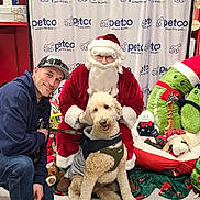 Dale White joined the competition — help win amazing prizes! background, beard, christmas, costume, curtain, decorations, dog, festive, floor, glasses, holiday, indoor, jacket, leash, man, person, petco, plush_toys, santa_claus, smile