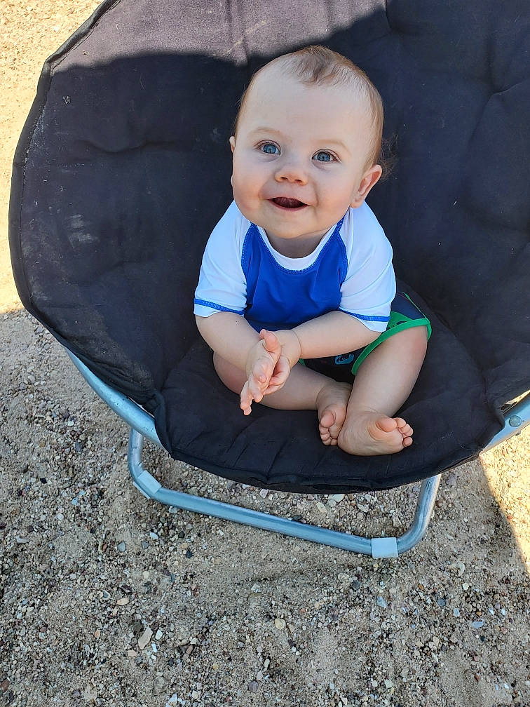 Zachariah joined the competition — help win amazing prizes! baby, baby_products, child, eye, face, facial_expression, grass, happy, head, joy, laugh, leisure, person, plant, play, product, sitting, skin, smile, toddler