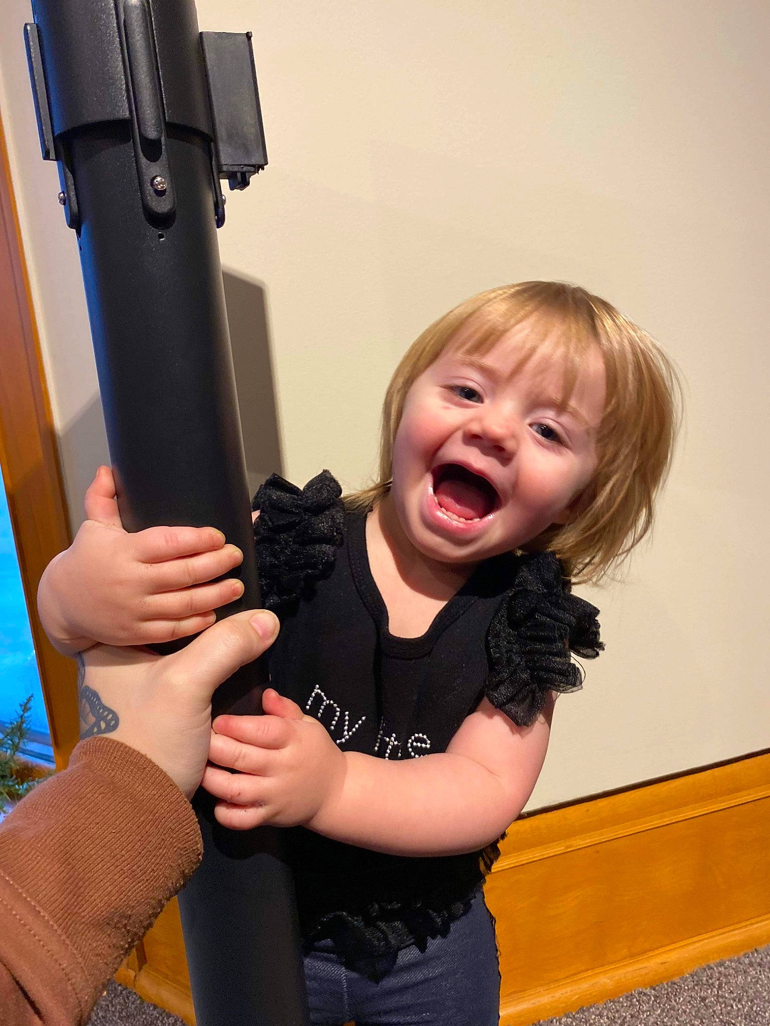 Hazel joined the competition — help win amazing prizes! arm, baby, child, entertainment, finger, fun, gesture, hand, happy, human_body, joint, laugh, person, room, sitting, smile, standing, t_shirt, thigh, thumb