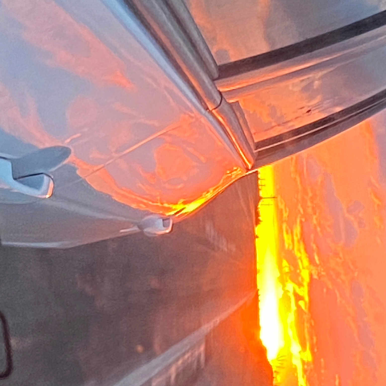 Emma is registered to the contest to win money with this photo: aircraft, amber, automotive_exterior, automotive_lighting, automotive_tail_brake_light, automotive_wheel_system, bumper, cloud, electric_blue, flame, gas, heat, hood, motor_vehicle, orange, sky, tints_and_shades, vehicle, vehicle_door, windshield