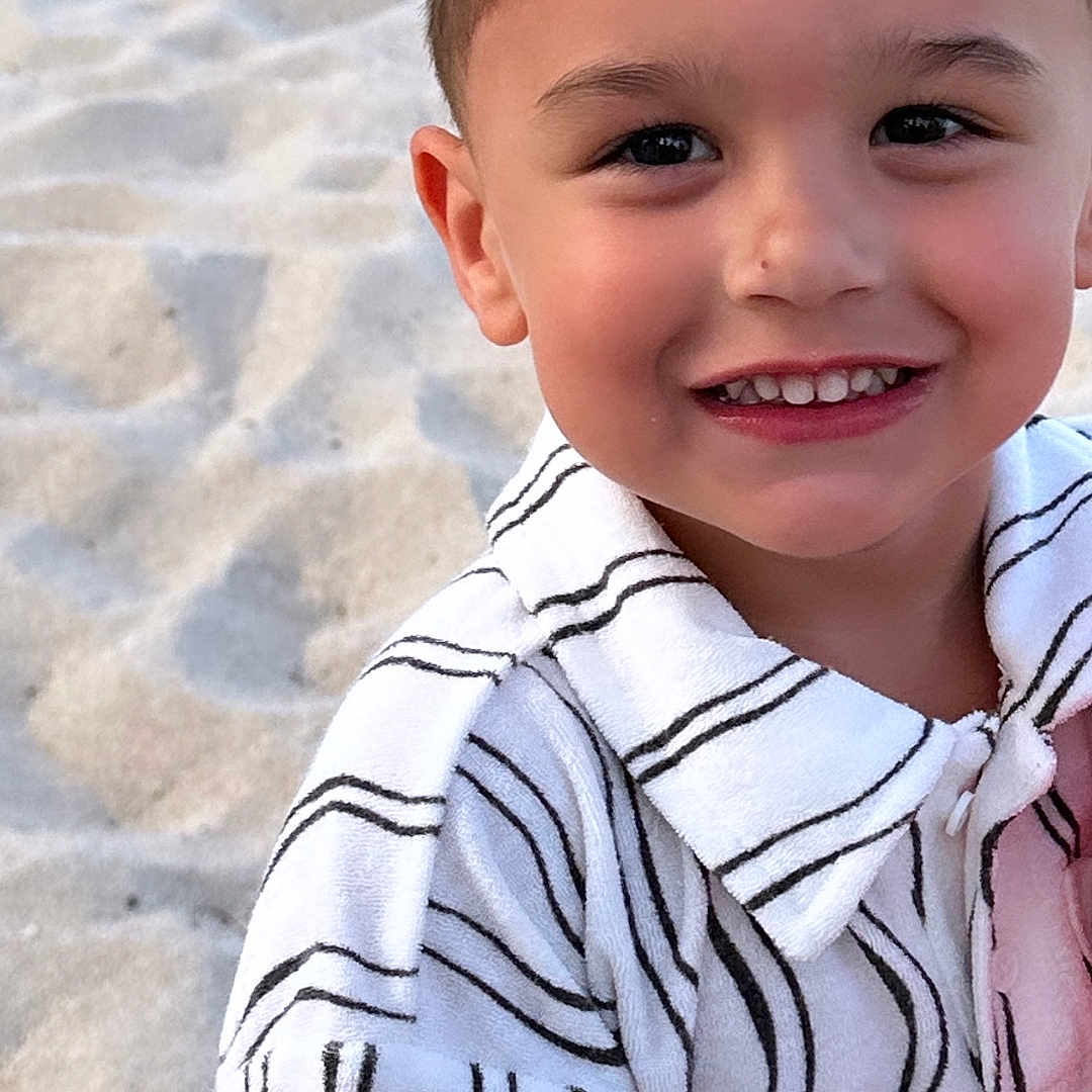 Adiel is registered to the contest to win money with this photo: accessories, beach, bodypart, boy, child, clothing, coast, face, happy, head, male, mouth, nature, outdoors, person, photography, portrait, shirt, smile, teeth