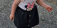 Meloane a rejoint le concours — aidez-le/la à gagner de superbes lots ! black_skirt, casual_stance, child, clothing, curious_expression, daylight, dry_grass, footwear, girl, inflatable_pool, minnie_mouse, outdoor, pebbled_path, pigtails, pink_sneakers, playful, portrait, shirt, standing, toddler