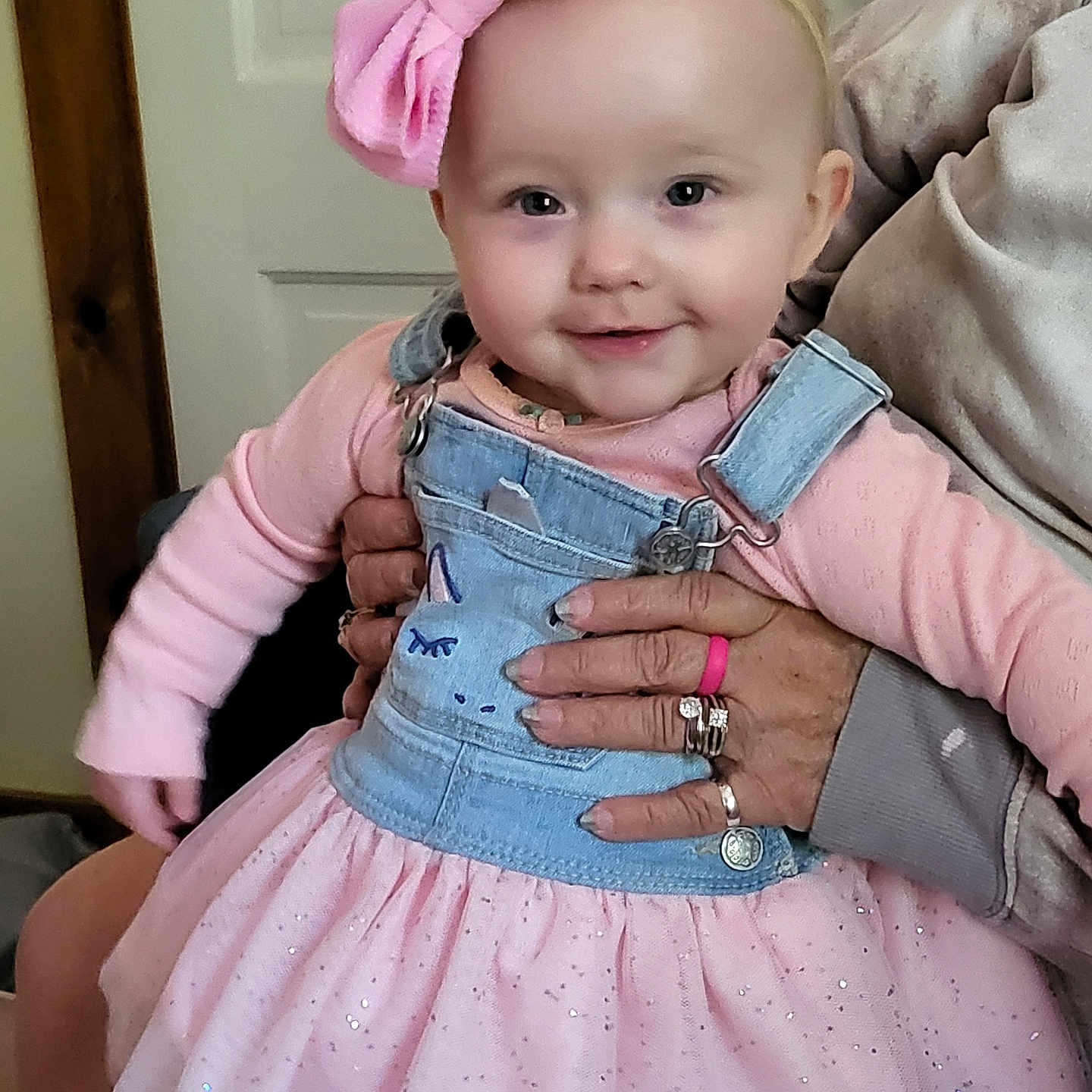 Auroarah is registered to the contest to win money with this photo: baby, child, clothing, cute, denim, dress, face, friendly, hand, happy, headband, holding, indoor, overalls, person, pink_bow, smile, sparkle, tutu, young_child