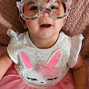 Ava joined the competition — help win amazing prizes! baby, child, glasses, bunny, pink_tutu, white_top, confetti, smiling, cute, portrait, face, happy, lying_down, cozy, blanket, fashion, costume, playful, infant, fun