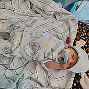 Joseph is registered to the contest to win money with this photo: baby, bed, blanket, bunny_ears, clothing, cute, hat, healthcare, hospital, infant, lying_down, medical, monitoring, newborn, pacifier, patient, person, small, striped_blanket, wired