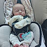 baby, infant, sleeping, car_seat, pacifier, clothing, blanket, foot, footwear, child, person, resting, comfort, cute, newborn, fabric, seatbelt, soft, indoors, peaceful