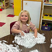 Remi joined the competition — help win amazing prizes! child, girl, smiling, play, foam, table, classroom, toys, learning, fun, blond_hair, face, hands, chair, sweater, happy, indoor, education, creative, messy