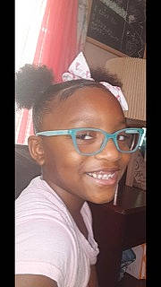 Amaris is registered to the contest to win money with this photo: black_hair, cheek, child, ear, eyebrow, eyelash, eyewear, fashion_accessory, forehead, fun, glasses, happy, jaw, joy, lip, magenta, nose, person, smile, t_shirt