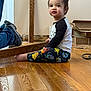 Alexander joined the competition — help win amazing prizes! child, toddler, sitting, hardwood_floor, monster_leggings, indoor, mirror_reflection, wood_plank, cardboard_boxes, barefoot, casual_clothing, portrait, curious_expression, home_interior, flooring, shoe, playful, young_child, renovation, gaze