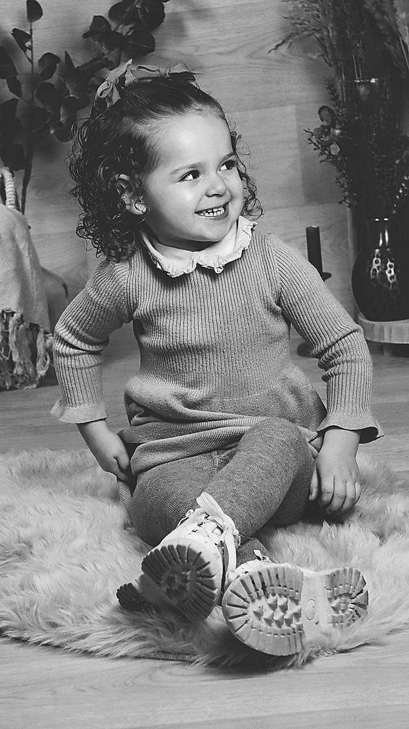 Celya a rejoint le concours — aidez-le/la à gagner de superbes lots ! black, black_and_white, cheek, child, dress, eye, facial_expression, fun, grass, hairstyle, happy, head, joy, monochrome, person, photograph, skin, smile, standing, style